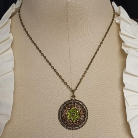 green flower on gold filigree necklace